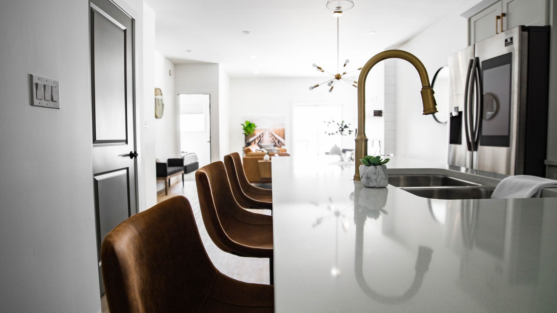 Bright kitchen with a sink and brass faucet; an illustrative photograph used on the company’s website